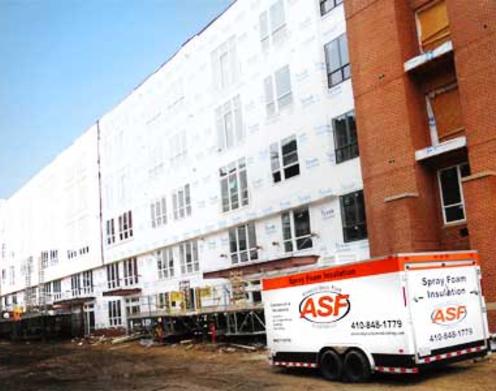 A white truck parked in front of a building.