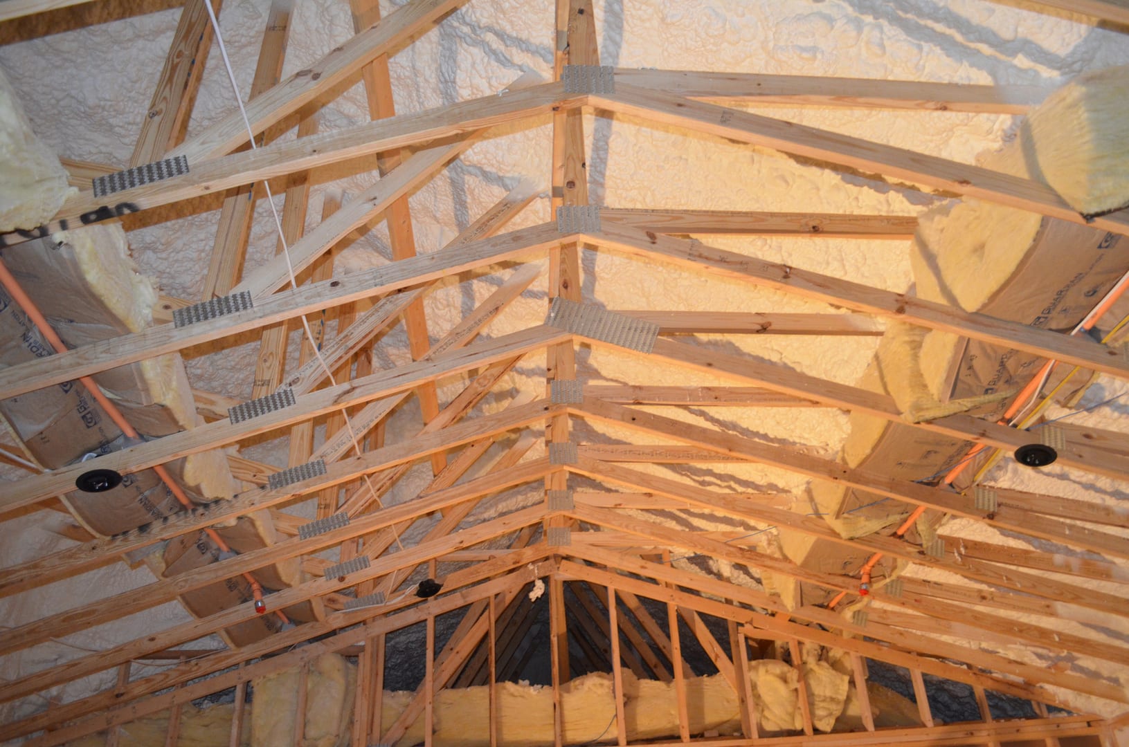 A view of the inside of a house with exposed rafters.